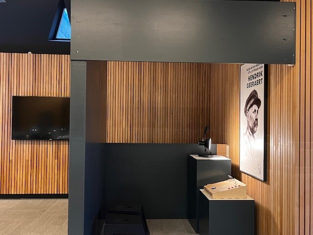 The Hendrik Geeraert booth at Westfront Nieuwpoort: his poster on a wooden slat wall next to the console with the microphone