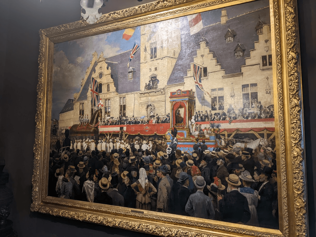 The Ros Beiaardommegang painting by Jan Verhas in its gold frame in the town hall of Dendermonde