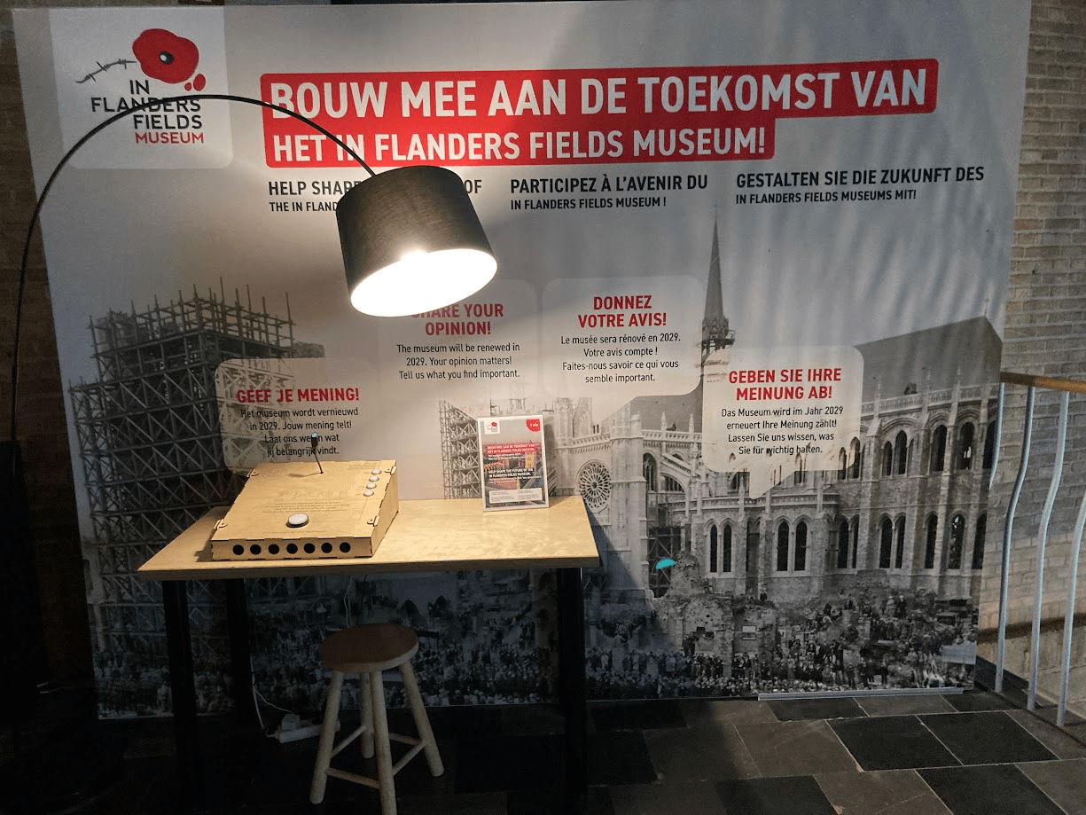 The full interview setup at the In Flanders Fields Museum: the console on its table with the banner and seat near the exit