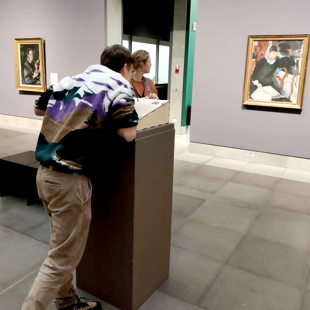 A visitor leans on the Talking Pictures console and talks to a painting at the Museum of Fine Arts Ghent